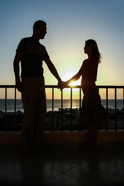 Beautiful couple silhouette on nature near the sea on a rift bac