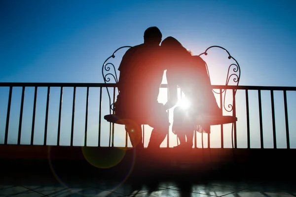 Beautiful couple silhouette on nature near the sea on a rift bac