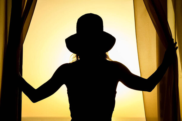 Silhouette of a girl on a chair on a nature background