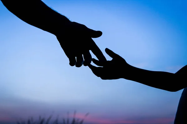 Felice padre genitore con bambino silhouette mano al tramonto in natur — Foto Stock