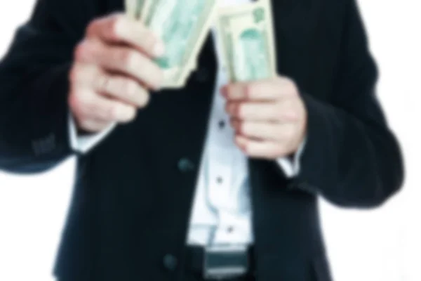 Επιχειρηματίας κρατώντας χρήματα σε λευκό φόντο — Φωτογραφία Αρχείου