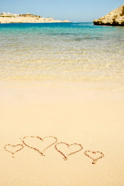 Beautiful drawing on the sand of the sea background — Stock Photo, Image