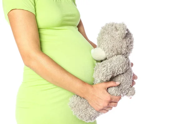 Felice ragazza incinta si trova su sfondo bianco — Foto Stock