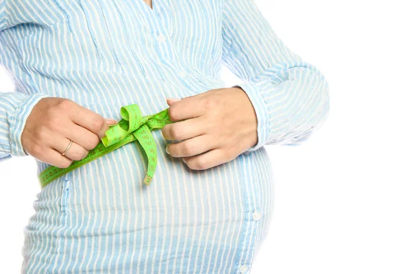 Happy pregnant girl lies on white background — Stock Photo, Image