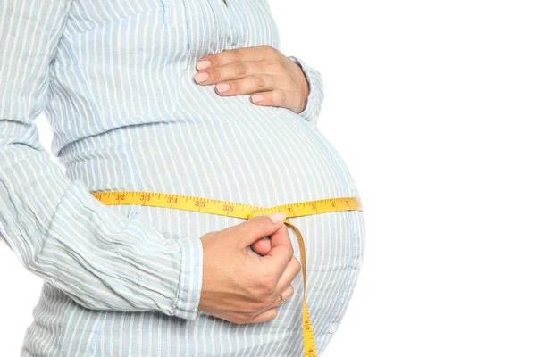 Happy pregnant girl lies on white background — Stock Photo, Image