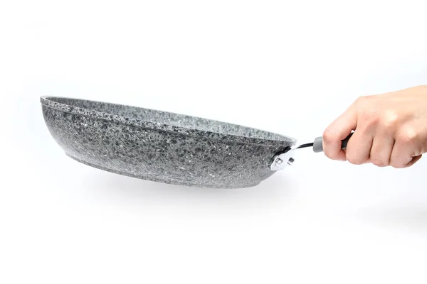 Stylish frying pan in hands on a white background — Stock Photo, Image