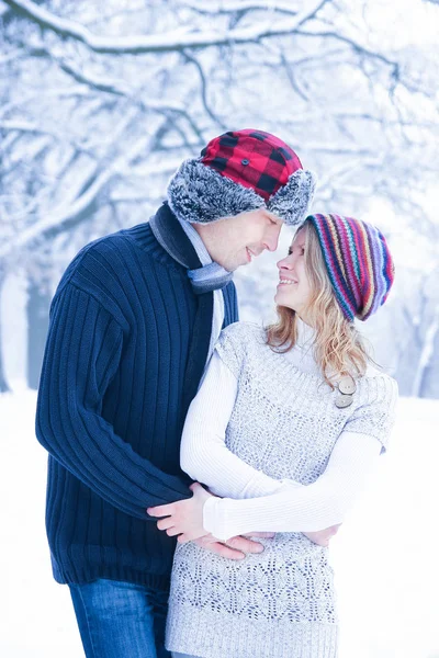 Stylish beautiful couple in winter park on a nature background — Stock Photo, Image