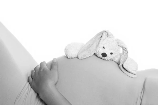 快乐的怀孕女孩躺在白色的背景下 — 图库照片