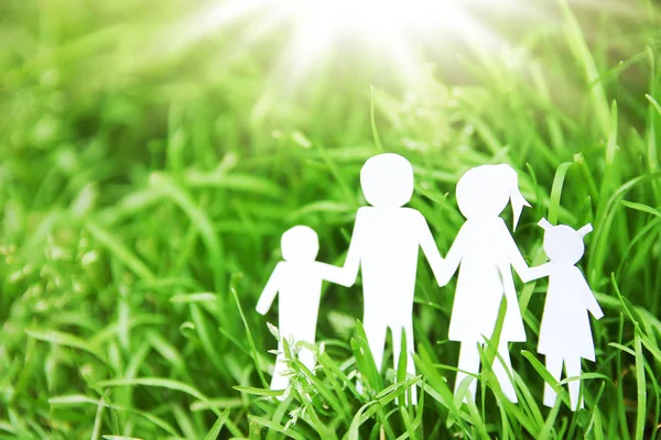 Paper family on a background of grass — Stock Photo, Image