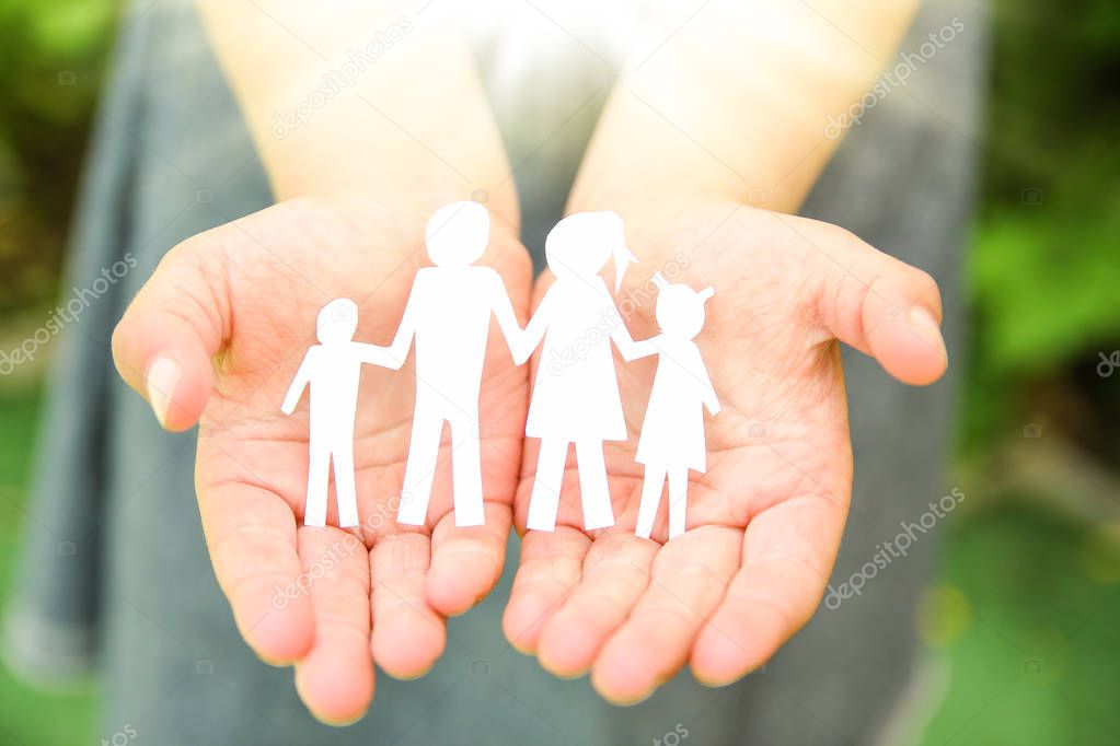 in the hands of the family on a background paper