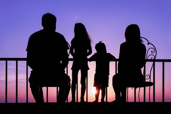Happy family at the dawn of the sea silhouette background — Stock Photo, Image