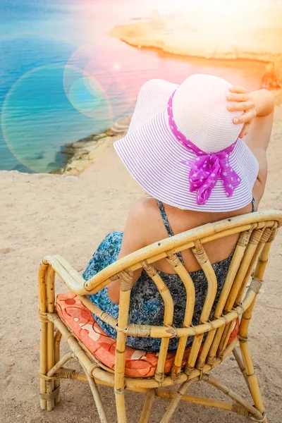 Stylish beautiful girl in hat on chair background — Stock Photo, Image