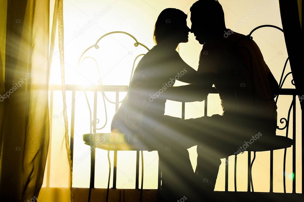 Beautiful couple silhouette on nature near the sea on a rift bac