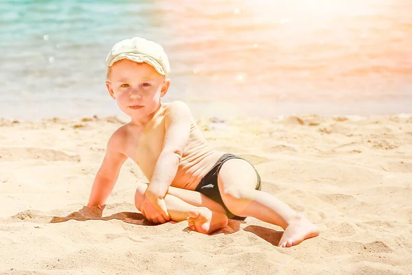 समुद्र पार्श्वभूमीवर खेळत आनंदी मुलगा — स्टॉक फोटो, इमेज