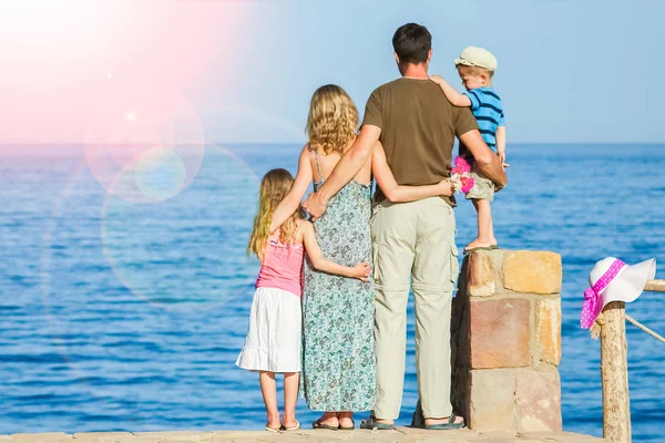 Happy parents with children playing on the sea background — Stock Photo, Image