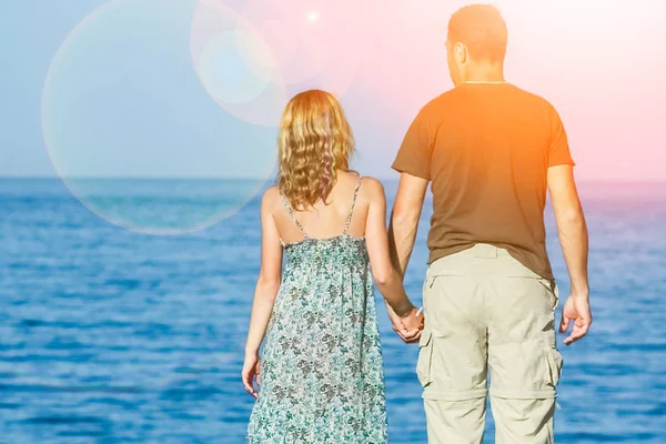 Beautiful happy couple on nature sea background — Stock Photo, Image