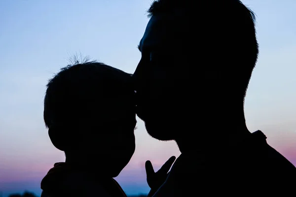 Père parent heureux avec silhouette de bébé dans un parc sur la nature — Photo