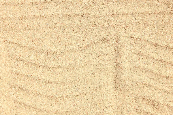 Prachtige tekening op het zand van de zee achtergrond — Stockfoto