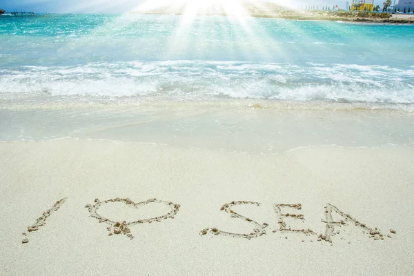 Beautiful drawing on the sand near the sea shore background — Stock Photo, Image