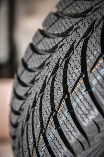 Black stylish new tire for cars on wheels — Stock Photo, Image