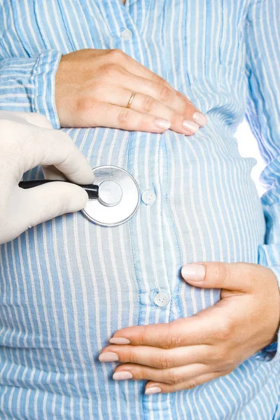 Happy pregnant girl lies on white background — Stock Photo, Image