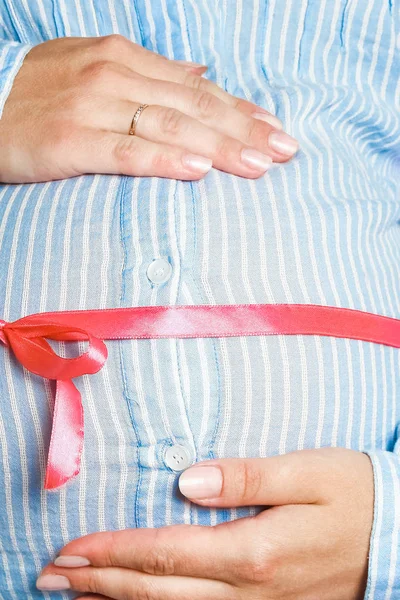 Happy pregnant girl lies on white background — Stock Photo, Image