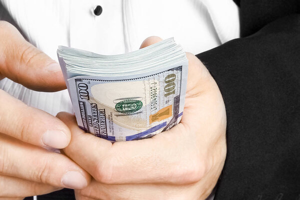 Business man holding money on white background