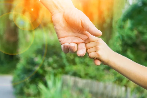 Le parent tenant la main de l'enfant avec un fond heureux — Photo