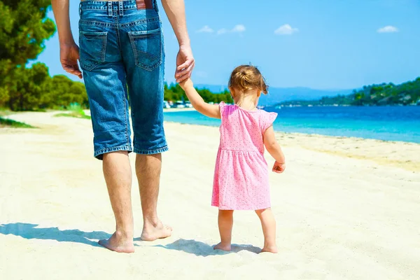 Beautiful hands of parent and child by the sea — Stock Photo, Image