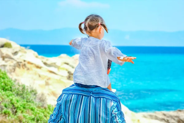 Gelukkige ouder met kind door de zee Griekenland buitenshuis — Stockfoto