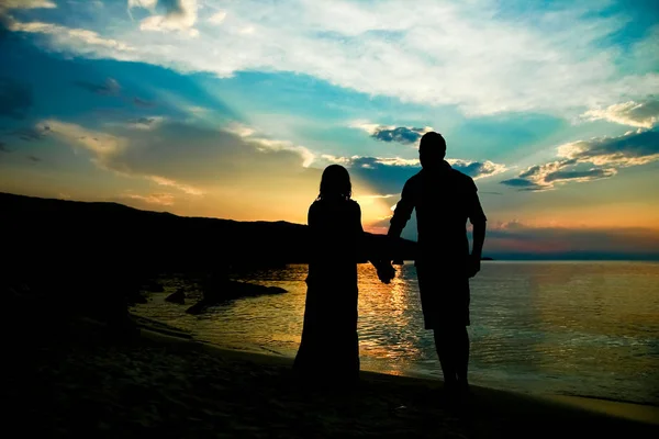 Szczęśliwa para sylwetka przez greckie morze na tle brzegu — Zdjęcie stockowe