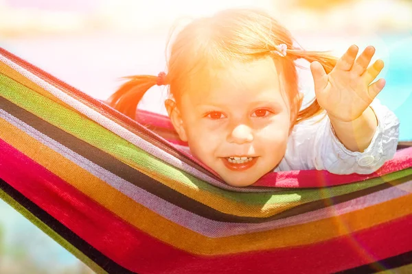 Glückliches Kind am Meer auf Hängematte im griechischen Hintergrund — Stockfoto