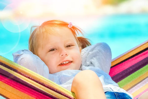 Happy child by the sea on hammock in greece background — Stock Photo, Image