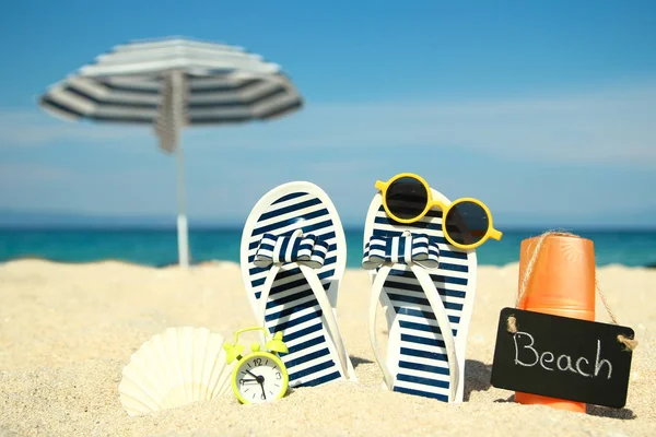 Family slippers on the sand on the beach — Stock Photo, Image