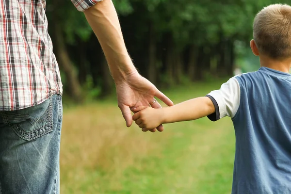 The parent holds the hand of a l child — Stock Photo, Image