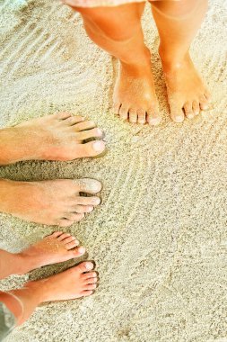 Deniz kenarındaki kumların üzerinde güzel bacaklar