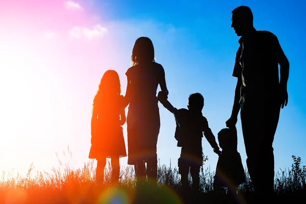 Happy family outdoors in the park silhouette — Stock Photo, Image