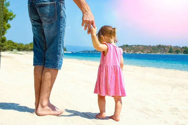 Beautiful hands of parent and child by the sea — Stock Photo, Image