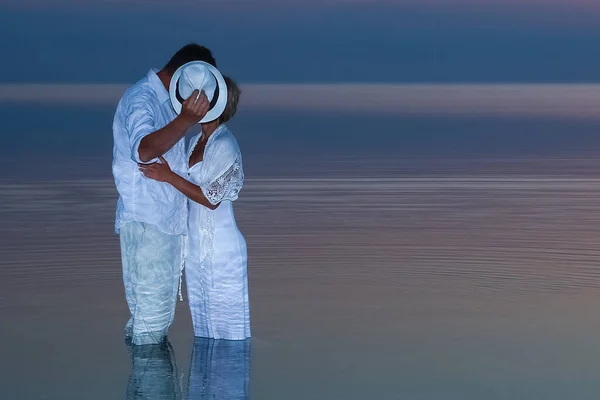 Happy couple by the sea in the nature of the sunset date travel