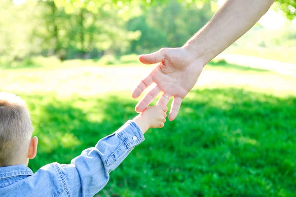 Orang Tua Memegang Tangan Seorang Anak Kecil Dan Berjalan — Stok Foto