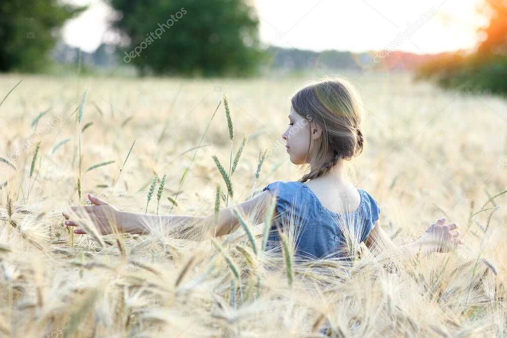 girl in a wheat field in summer