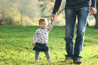 Ebeveyn küçük bir çocuğun elini tutar.