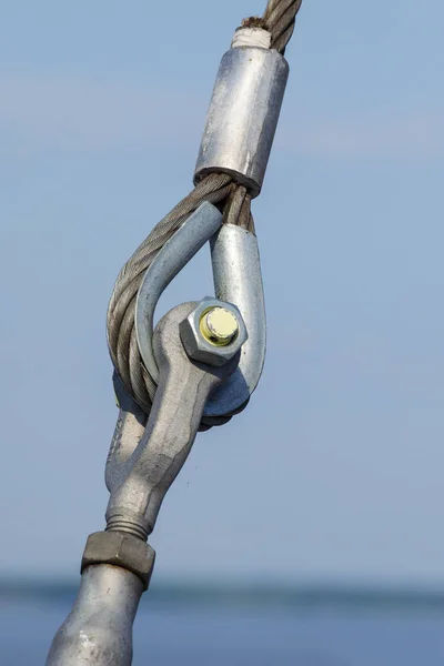 Loop connections of steel rope. Metal fastening element in ferry.