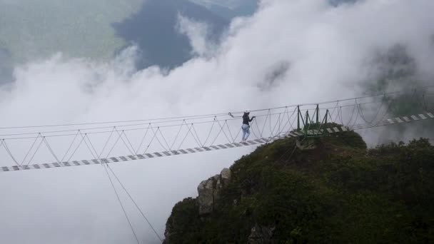 People Walk Suspension Bridge Mountains Clouds — Stock Video