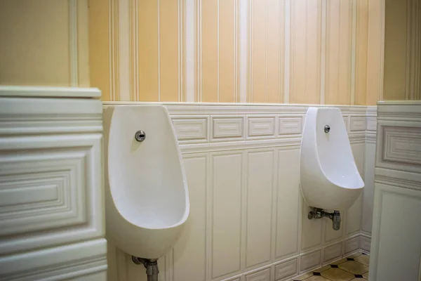 Sensor urinal on the wall. Rest room for men.