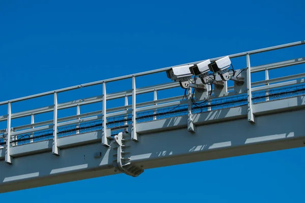 Three cameras on a metal construction. Industrial supervision. Motorway, highway speed cameras.