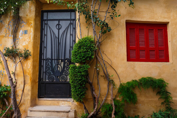 Plants and an old building in Anafiotika neighborhood in the old town of Athens, Greece.