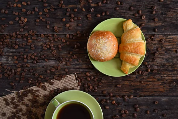 Coffee mood on rustic wooden table, croissant and coffee