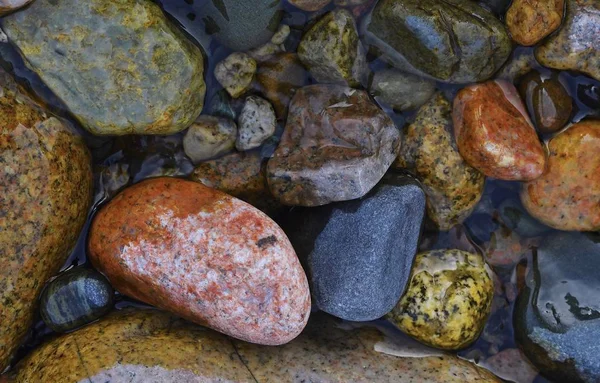 Composition of colored stones. Stones from a mountain river in the mountains of Kyrgyzstan