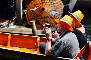 Damnoen Saduak Yüzen Pazarı, Tayland - 7 Ekim 2008: Turistler popüler turistik bölgede kayıkla gezmeye giderler 